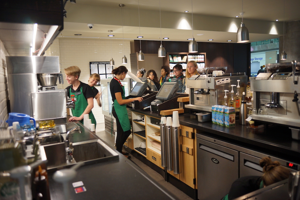 Starbucks employees making drinks for customers