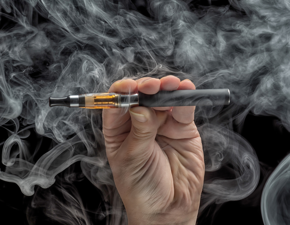 vaping man holding an e-cigarette