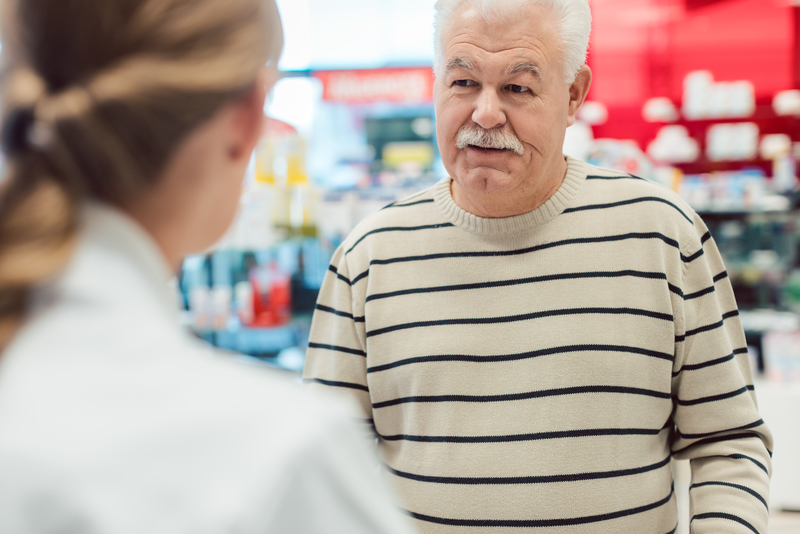 senior man filling prescription for vidodin