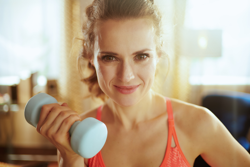 healthy, sober,  fit woman holding a dumbell