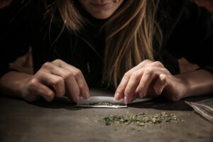 women with cannabis use disorder rolling a joint