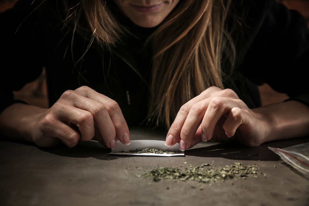 women with cannabis use disorder rolling a joint