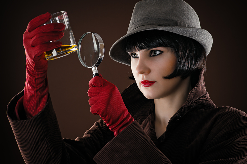 Female detective inspecting a glass of booze