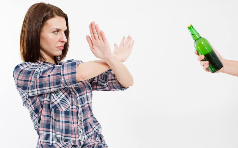 Woman refusing a beer