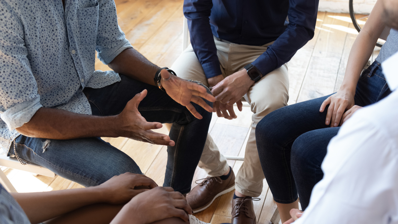 hands of people in a group session in treatment