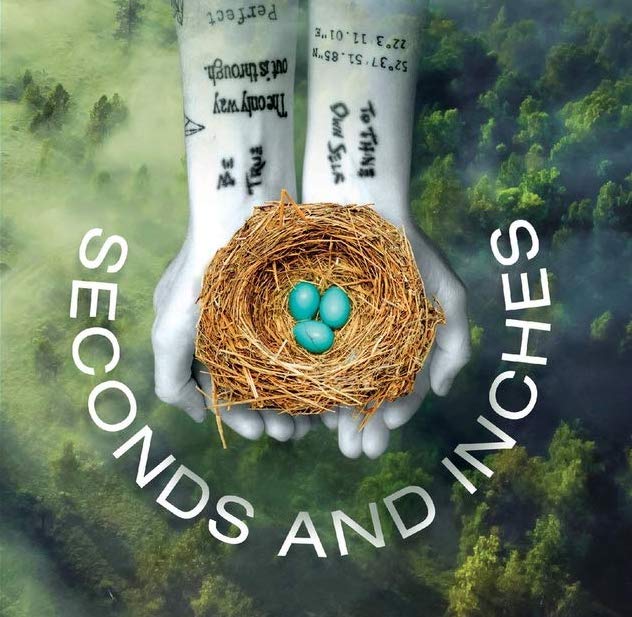 Tattooed hands holding a nest with blue eggs. Book cover with title "Seconds and Inches"