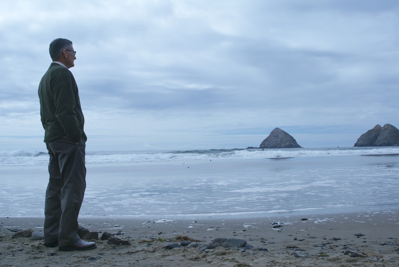 Man standing alone, looking out over the water