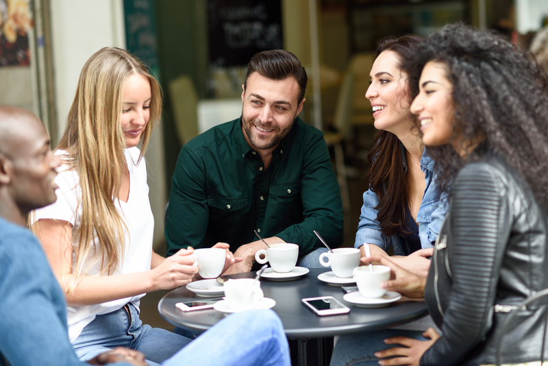 Friends sit together having coffee