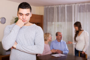 man separated from family, sad or pensive